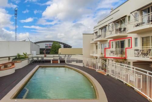 a swimming pool on the roof of a building at Inner City One Bedroom Apartment with Pool View 22 in Cairns