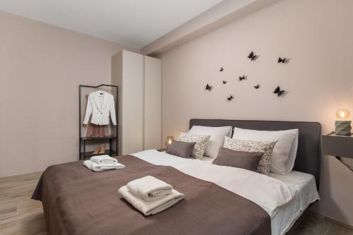 a bedroom with a large bed with towels on it at Apartment HANA in Pješčana Uvala 