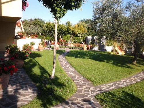 a garden with a cobblestone path in the grass at Poggio La Grognola in Cannara
