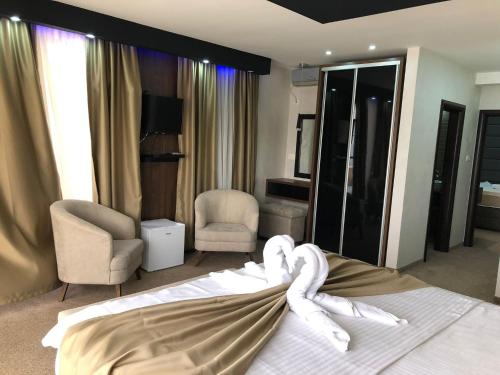a bedroom with a bed with a white towel on it at Apart Lux Beciragic in Dobra Voda