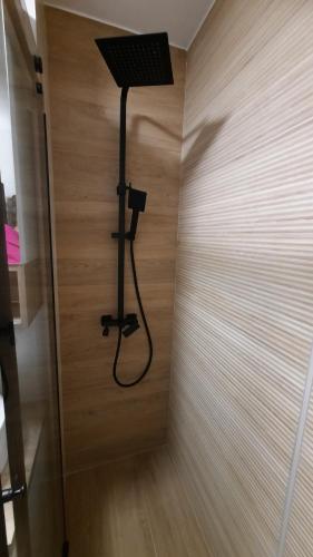 a room with a light on a wooden wall at Lala Boho apartment 2nd floor in Sarajevo