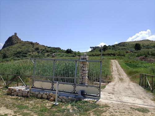 a gate on the side of a dirt road at Casolare La Torre in Scopello