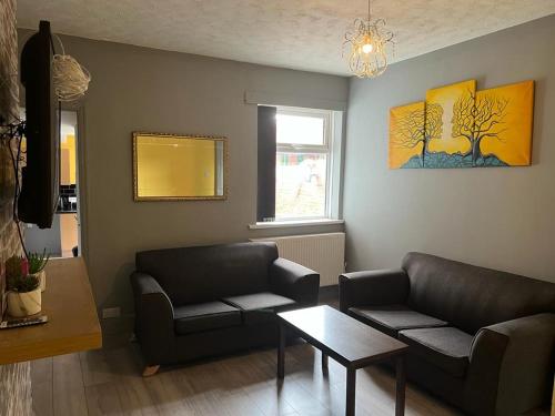 a living room with two couches and a table at Nuns Moor fully equipped kitchen free parking Netflix in Newcastle upon Tyne