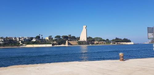 a fire hydrant sitting on the side of a body of water at Maris Terra in Brindisi