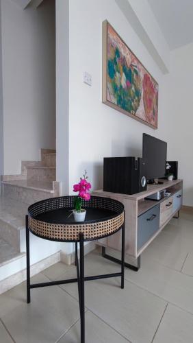 a table with a flower on it in a room at Lovely holiday home,Kapparis,2 swimming pools,Wifi in Paralimni
