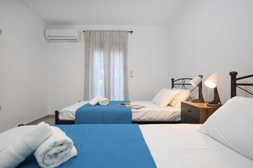 A bed or beds in a room at Ionian White - Apartment C