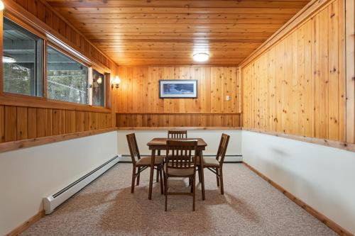 a dining room with a table and chairs at SILK Cabin in Manitowish Waters