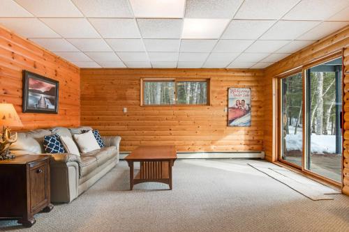 a living room with a couch and a table at SILK Cabin in Manitowish Waters