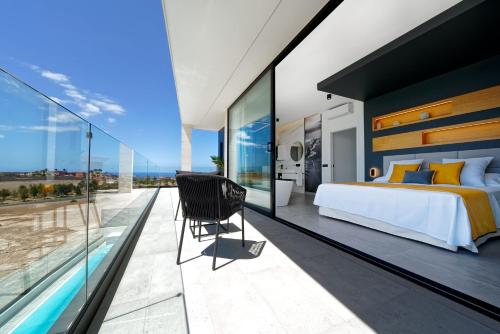 a bedroom with a bed and a swimming pool at Villa Sant Meloneras in Meloneras
