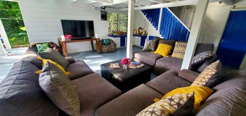 a living room with a couch and a tv at Bak A Yaad in Negril