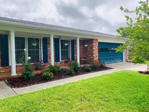 a house with blue doors and a lawn at Cush Jax Baymeadows Ranch, Close to Everything! in Jacksonville