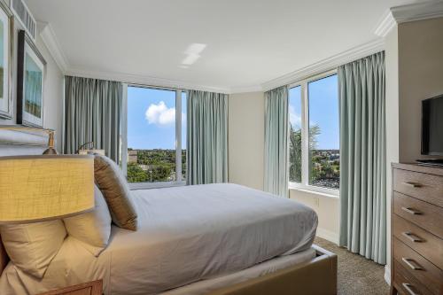 a bedroom with a bed and a large window at Marco Beach Ocean Resort IV in Marco Island