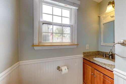 a bathroom with a sink and a window at Poppy P-Town in Provincetown