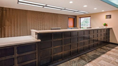 a waiting area in a dental office with wood paneling at Best Western Warren Hotel in Warren