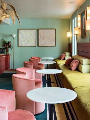 a row of tables and chairs in a room at Hôtel Mercedes in Paris