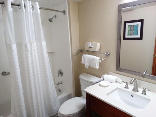a bathroom with a white toilet and a sink at Best Western Warren Hotel in Warren