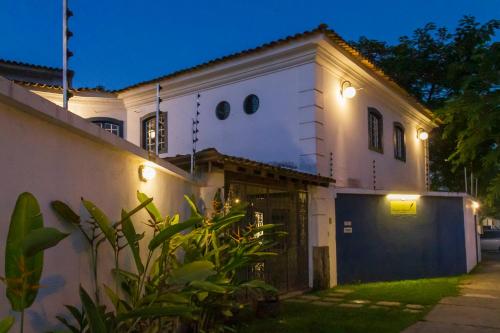 a white house with a garage at night at Pousada Casa dos Autores in Paraty