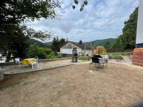 a yard with chairs and a table and chairs at Maharaja Ferienhaus in Hemfurth-Edersee