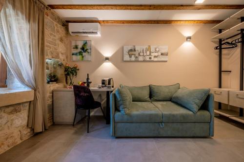 a living room with a couch and a table at Old Spalatrum Luxury Rooms in Split