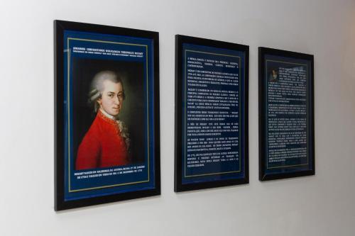 a group of four framed pictures on a wall at Pousada Casa dos Autores in Paraty