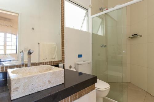 a bathroom with a sink and a toilet and a shower at Pousada Casa dos Autores in Paraty