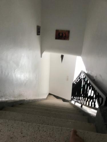 an empty hallway with a staircase and a stair case at Dar el Koutoubia in Marrakech