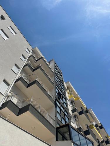 an image of an apartment building with balconies at Twentysix Apartment in Shkodër