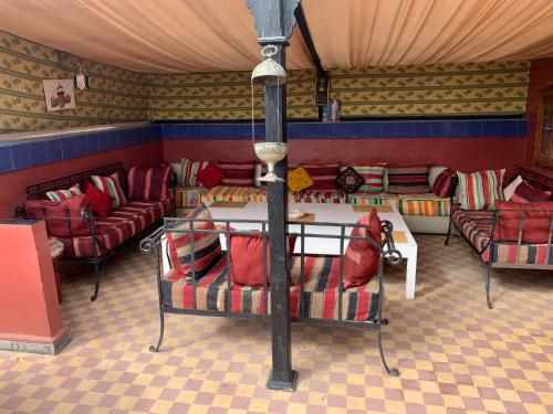 a living room with couches and a table and chairs at Dar el Koutoubia in Marrakech