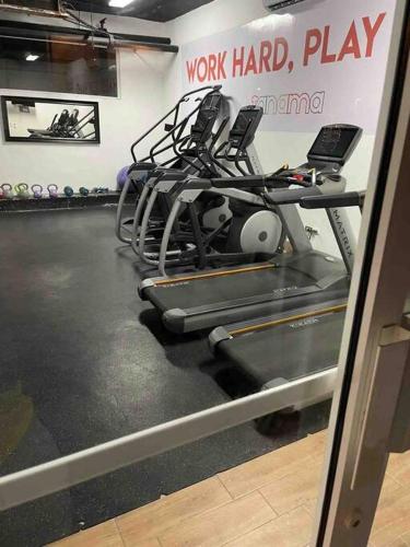 a gym with a treadmill and a work hard gym at Espectacular Apartamento En Tanama Cap Cana in Punta Cana