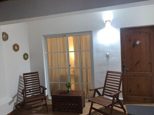 two rocking chairs and a table in a room at Espectacular Apartamento En Tanama Cap Cana in Punta Cana