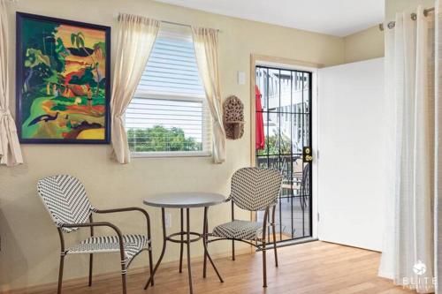 a dining room with chairs and a table and a window at The Sanctuary in Captain Cook