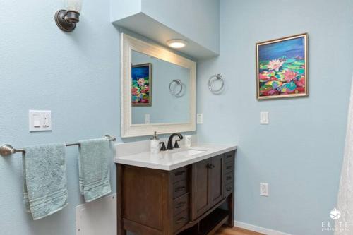 a bathroom with a sink and a mirror at The Sanctuary in Captain Cook