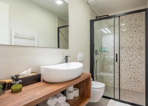 a bathroom with a white sink and a shower at Old Spalatrum Luxury Rooms in Split