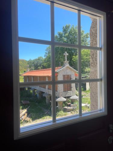 a window view of a church from a house at Casa do Afonso in Brufe