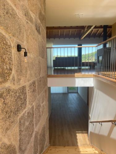 a room with a stone wall and a staircase at Casa do Afonso in Brufe