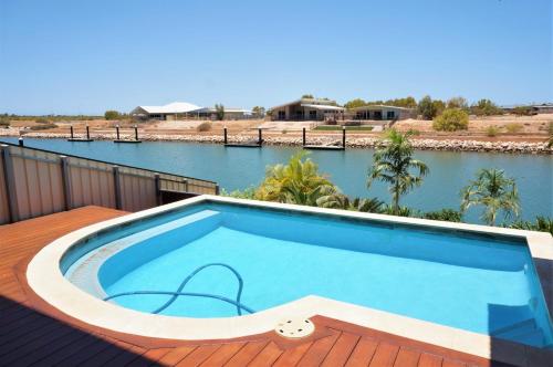 a swimming pool on the deck of a house at 27 Corella Court in Exmouth