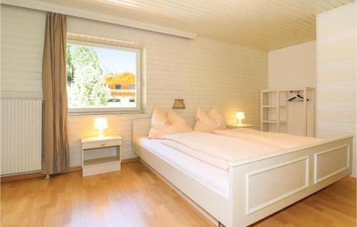 a white bed in a room with a window at 10 Bedroom Stunning Home In Sankt Sigmund in Sankt Sigmund im Sellrain