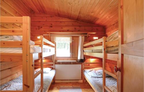 a bedroom with bunk beds in a log cabin at 2 Bedroom Stunning Home In rkelljunga in Fasalt