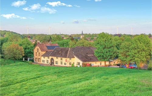 a large house on a hill with a green field at Vakantiewoning 4 in Simpelveld