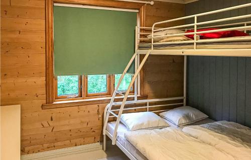 a bedroom with bunk beds in a log cabin at 4 Bedroom Gorgeous Home In Erfjord in Erfjord