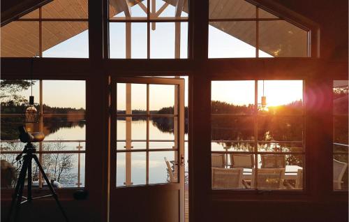 um quarto com vista para um lago através de uma janela em Gorgeous Home In rjng With Wifi em Östra Viker