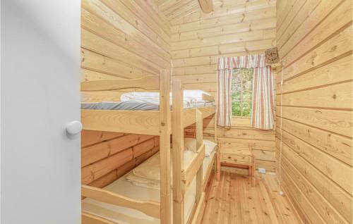 a log cabin with a bunk bed and a window at Beautiful Home In Olden With Sauna in Olden