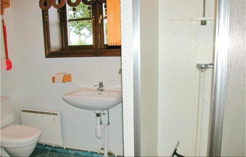 a bathroom with a sink and a toilet at Awesome Home In Slen With 3 Bedrooms And Sauna in Lindvallen