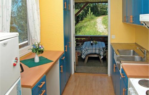 a small kitchen with a table and a sink and a table at Amazing Home In Sandvoll With 3 Bedrooms And Internet in Sandvoll