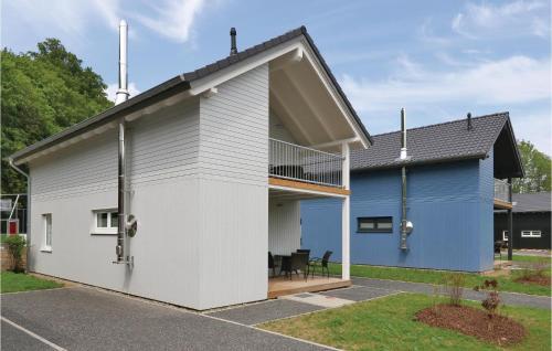 a blue and white house with a balcony at Ferienhausdorf Thale in Thale