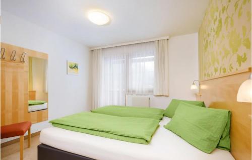 フラッハウにあるStunning Apartment In Flachau With 2 Bedrooms And Wifiのベッドルーム1室(緑のシーツが敷かれたベッド1台、窓付)