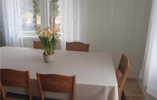 a white table with chairs and a vase of flowers on it at Beautiful Home In Vega With Wifi in Holand