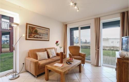 a living room with a couch and a table at Amazing Apartment In Rechlin With Sauna in Rechlin