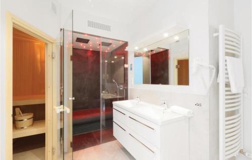 a white bathroom with a shower and a sink at Promenadenvilla in Travemünde