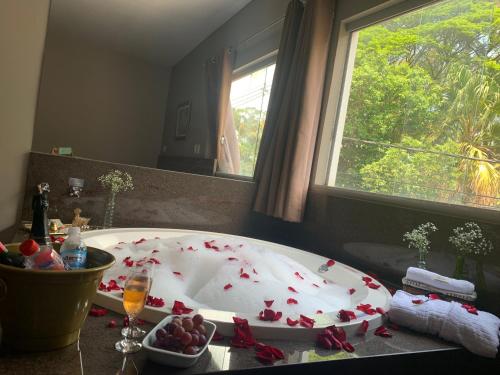 a large white bath tub with red hearts on it at CAMBRAIA HOTEL ARCOS in Arcos
